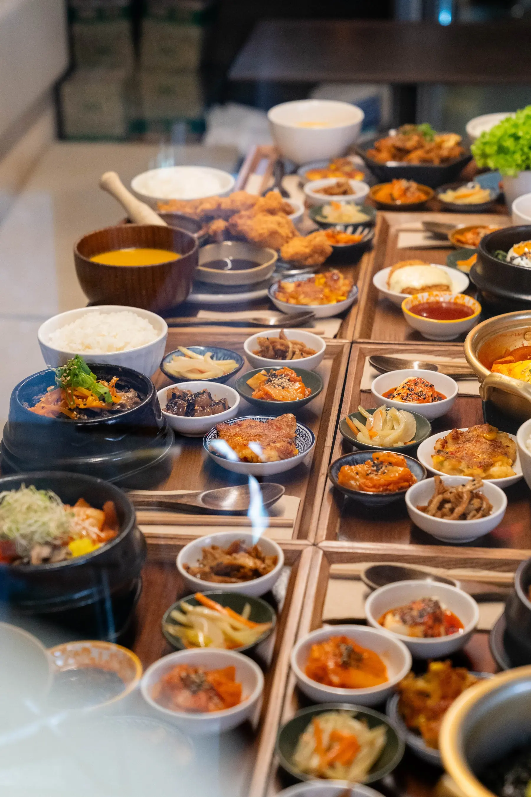 A full table of WATDA Korean mains, rice, soup and banchan